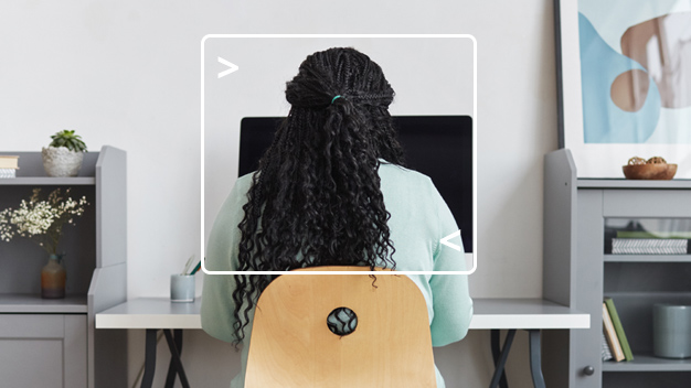 woman sitting at computer at home with computer terminal framing her