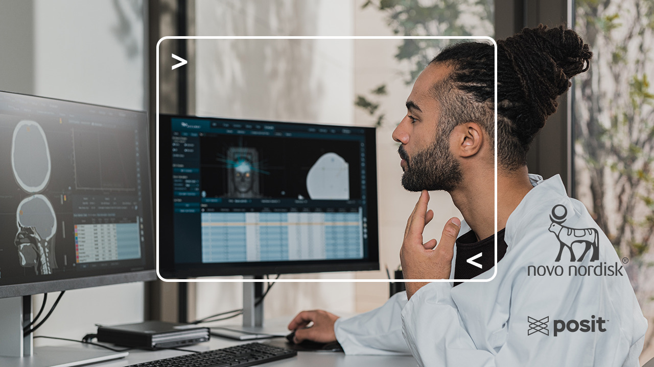 Man looking at data visualizations on two monitors